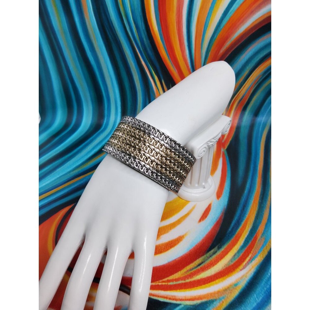 Vintage silver tone cuff bracelet featuring spring hinge , 1.25" wide x 2.38" di